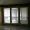 Dining room picture in the house for rent in Watauga. It has three large windows to a small open patio area and tile floor.